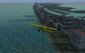 Piper Cub flying along Miami Beach on a hazy afternoon.