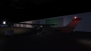 aircraft sitting in the dark, all lights on