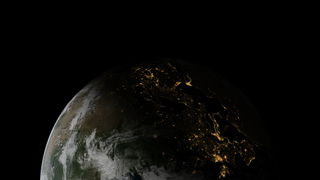 Earth from 6000km with night-side lit up by city lights.