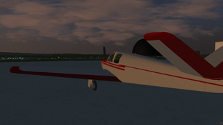 The Beech Bonanza at KAKR. The Goodyear Airdock is visible behind the plane.