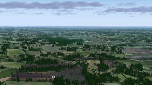 Rolling agricultural lands stretching away to the horizon in southern France in FlightGear 2020.x